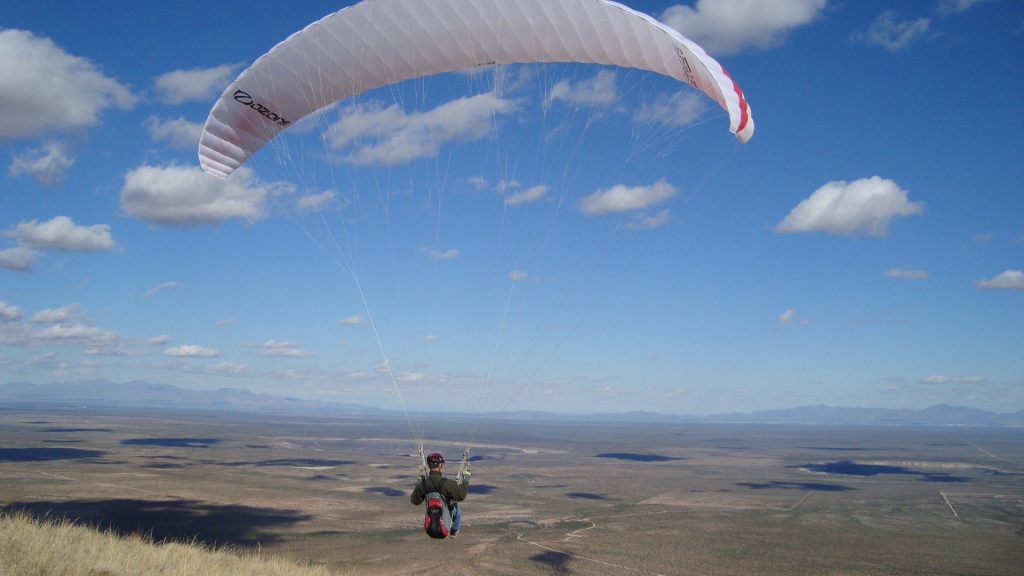 launching a paraglider from the summit of Mt. Riley