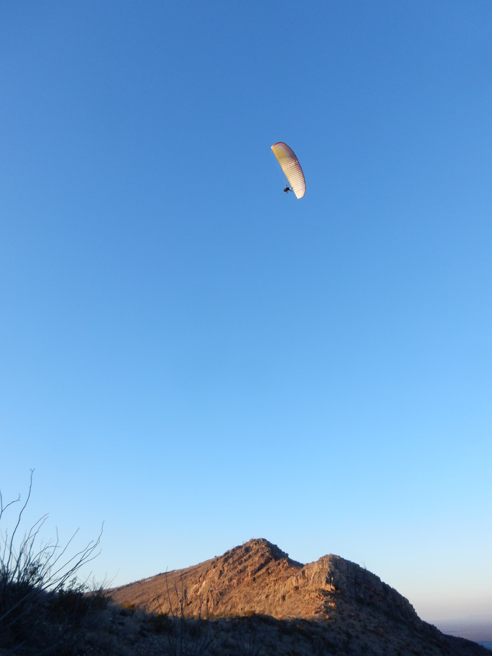 paraglider soaring over the East Potrillo Mountains