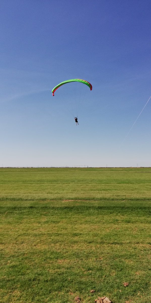 paraglidier launching with a cravat