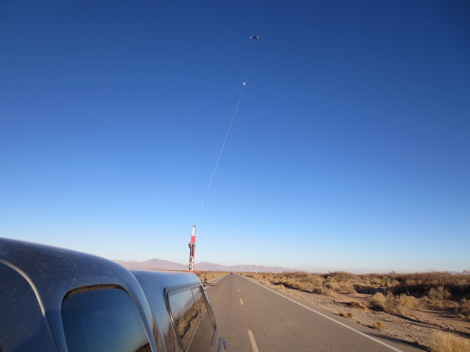 paraglider being towed up with a winch